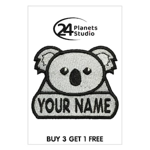 May include: A gray and black embroidered iron-on patch featuring a koala with the text "YOUR NAME" below. The patch is from 24 Planets Studio.