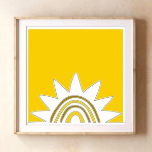 May include: A square wall art print featuring a bright yellow background with a stylized white sun graphic. The sun design includes concentric gold-toned arched lines within its center, all enclosed in a simple, thin white frame.