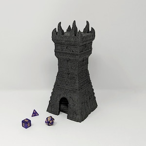 May include: A black 3D printed tower with a pointed roof and a small entrance. Three purple dice with gold numbers are in front of the tower.