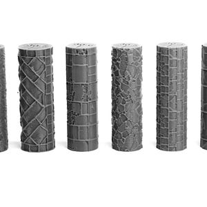 May include: A collection of ten gray cylindrical objects with various textured patterns. The designs include wood grain, stacked segments, geometric shapes, and stone-like textures. Each cylinder stands upright, showcasing its unique surface detail.