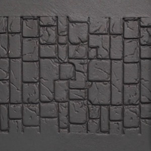 May include: A dark gray, textured surface with a cobblestone pattern. A cylindrical piece with a matching cobblestone design is positioned to the right. The items appear to be for a miniature or model project.