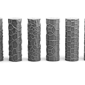 May include: A collection of nine gray cylindrical objects with varied textured surfaces. The textures include patterns resembling wood grain, cracked earth, and geometric designs. Each cylinder stands upright, showcasing its unique surface detail.