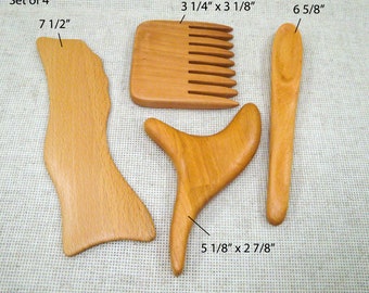 May include: Set of four wooden Gua Sha massage tools. The tools are in various shapes and sizes, including a comb, a spoon, and two curved tools. The tools are made of natural wood and have a light brown color. The tools are labeled with their dimensions in inches.
