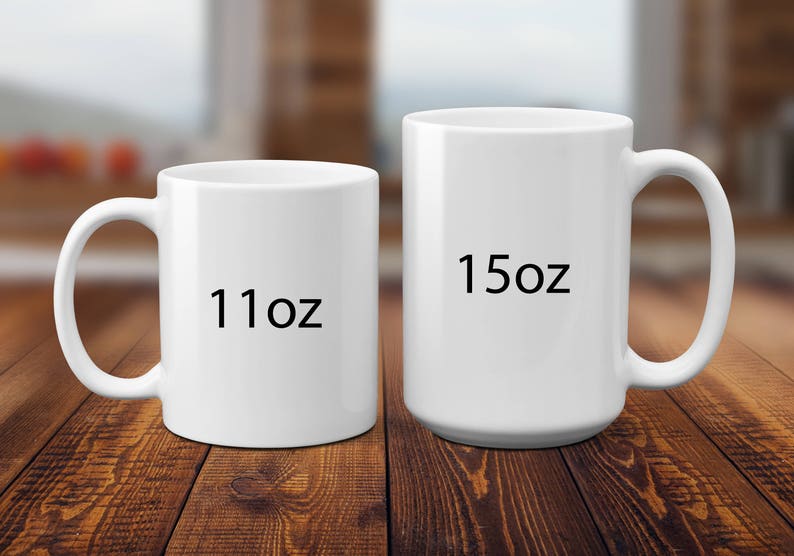 May include: Two white ceramic mugs with handles, one smaller mug labeled 11oz and one larger mug labeled 15oz. The mugs are plain, cylindrical, and feature a smooth, glossy finish. The text 11oz and 15oz is printed in black on the front of each mug.