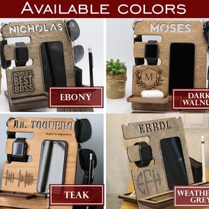May include: Four wooden phone stands with different wood finishes: Ebony, Dark Walnut, Teak, and Weathered Grey. Each stand features a personalized name, a space for a phone, a watch, and other accessories. The stands are ideal for organizing a desk or nightstand.