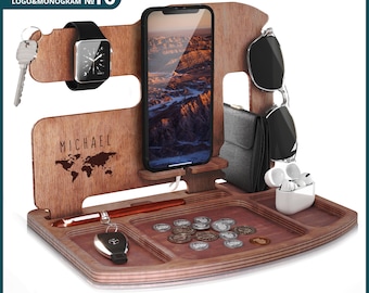 May include: A wooden phone stand with a dark walnut finish. It has a slot for a phone, a watch, keys, and glasses. The stand also has a small tray for other items. The stand is personalized with the name "MICHAEL" and a world map design.
