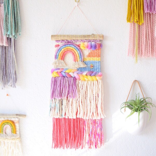 Woven wall hanging with colorful rainbow and braid. Rainbow and pink modern boho decor for nursery. Made to order weaving.
