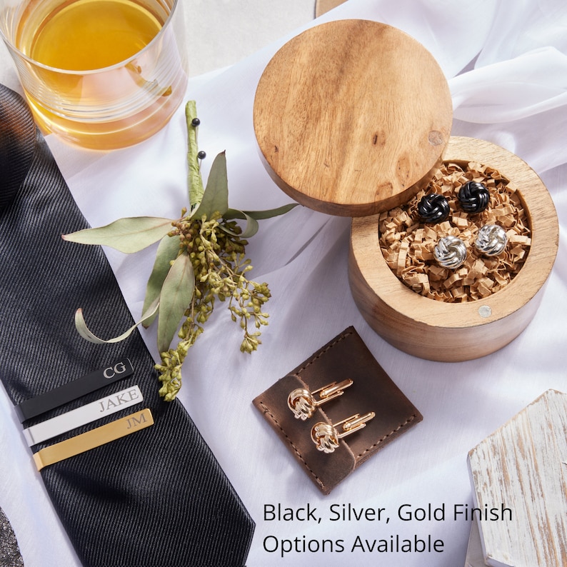 Groomsmen gift box comes with personalized tie clip and knot cufflinks. Black, Silver and Gold finish available for time to suit up groomsman gift box.