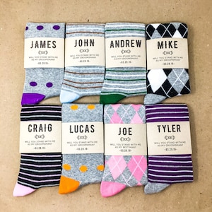 8 pairs of mix and match groomsmen dress socks with custom proposal labels. Groomsmen proposal gift for wedding party. Personalized label includes name, will you stand with me as my groomsman; and wedding date.