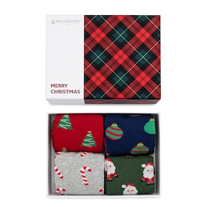 May include: A set of four pairs of Christmas socks in a white box with a red and green plaid lid. The lid has the text "NO COLD FEET CO." and "MERRY CHRISTMAS". The socks feature Christmas trees, ornaments, candy canes, and Santa Claus.