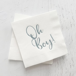 May include: White paper napkins with the text "Oh Boy!" printed in light blue.