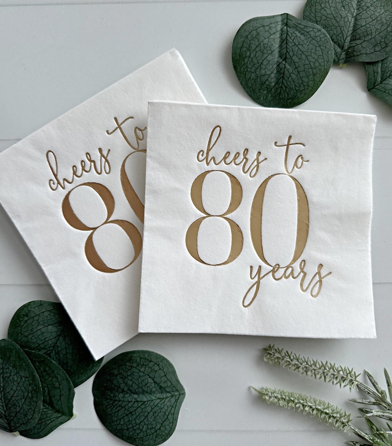 Raise a toast to 80 remarkable years with our "Cheers to 80 Years" Cocktail Napkins featuring stunning gold foil accents! These napkins are the perfect addition to your 80th birthday celebration