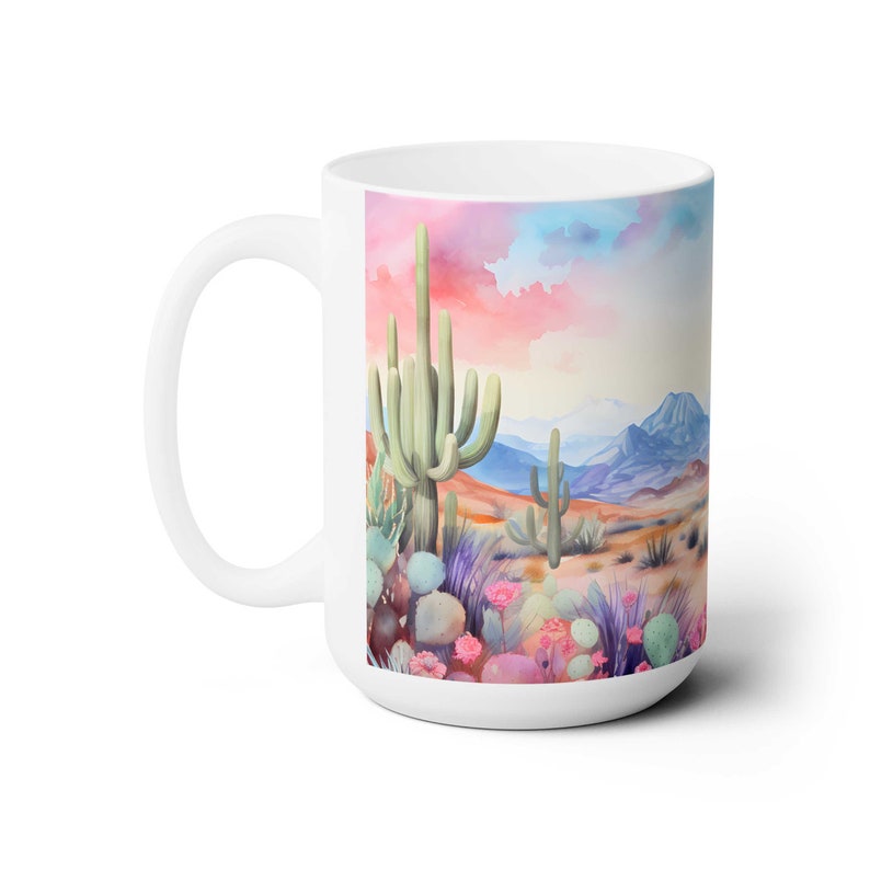 May include: White ceramic mug with a colorful watercolor illustration of a desert landscape featuring cacti, flowers, and a pink and blue sky.