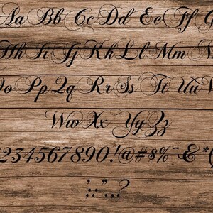 May include: A black and white image of a handwritten alphabet and numbers on a wood background. The letters are in a cursive font with decorative flourishes. The numbers are in a simple, blocky font.