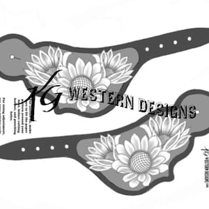 May include: Two grayscale spur straps featuring sunflower designs. The straps have a dark grey background with a lighter grey floral design. The text "TG WESTERN DESIGNS" is visible.
