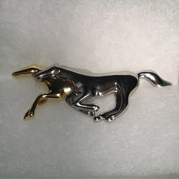 Signed LC (Liz Claiborne) brooch pin, two horses (one goldtone and one silvertone) galloping beside each other.