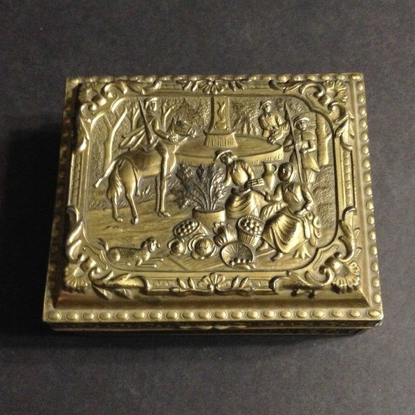 Metal trinket box, wood lined, mid-century, made in Japan, repoussé market scene on lid, four footed, probably brass.