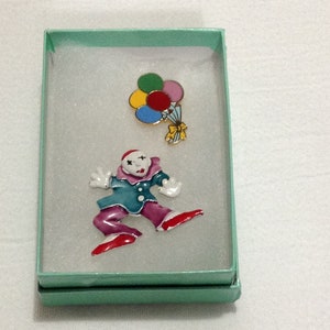 Two pins, a colorful clown and colorful balloons, painted clown has no maker&#39;s mark, balloon pin is marked Gift Creations.