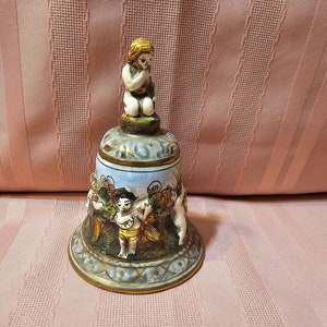 Vintage Capodimonte bell, tall, cherubs, made in Italy, 1366/135, gold trim, original creation by KB sticker, collectible, small chip.