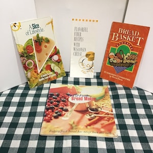 Group of 3 cookbooklets and 1 pamphlet, 2 about bread and 2 about cheese, being sold together for one price; many recipes and how-to guides.