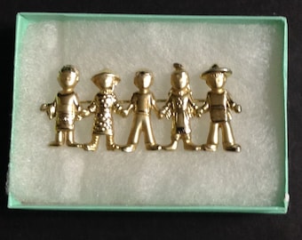 Signed AJC Children of the World brooch pin, gold tone, 1980s,