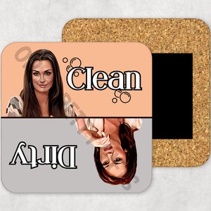 May include: A cork-backed magnetic sign with a light peach background. The sign has the words "Dirty" and "Clean" written in black. The sign features a woman's face on each side, one upside down.