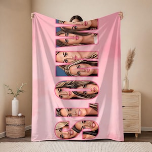 May include: A pink blanket with the word "SOUL" in large, pink, stylized letters. Each letter is composed of a portrait of a woman's face. The blanket is held up by a person.