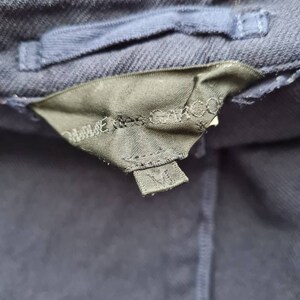 May include: A navy blue jacket with a black label that says "Made in China" and a size tag that says "M".