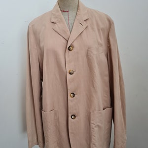 May include: A light brown linen blazer with a four-button closure and two patch pockets.