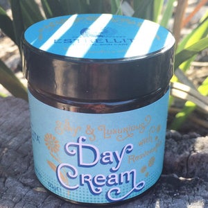 May include: A blue and gold jar of day cream with the text "Silky & Luxurious Day Cream with Resveratrol" on the label. The jar is 50g.