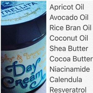 May include: A white jar with a blue and gold label that reads "Silky & Luxurious Day Cream". The jar is labeled with the brand name "TRELLITA" and the ingredients: Apricot Oil, Avocado Oil, Rice Bran Oil, Coconut Oil, Shea Butter, Cocoa Butter, Niacinamide, Calendula, and Resveratrol.
