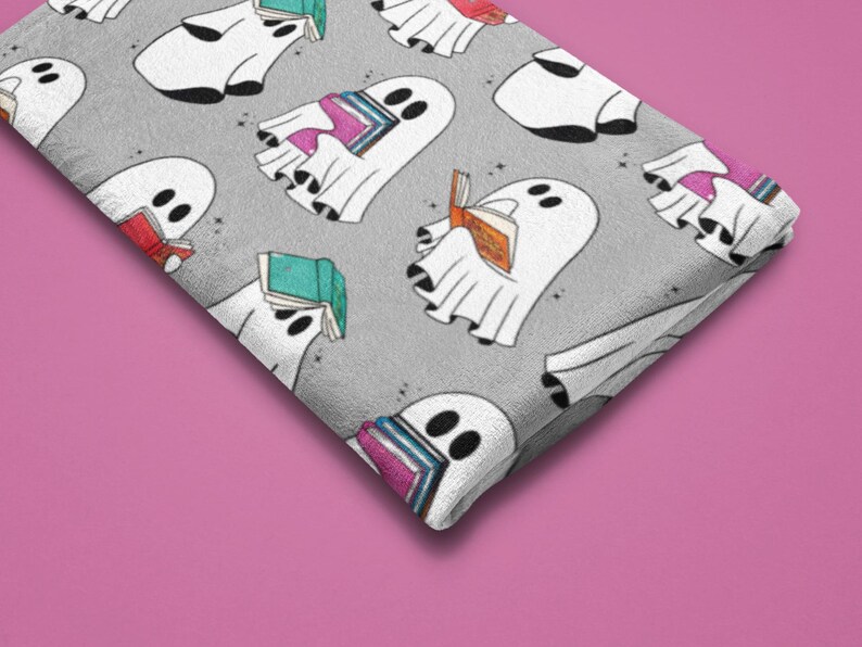 May include: A gray fabric with a repeating pattern of white ghosts reading books. The ghosts are in various poses, some sitting, some standing, and some floating. The books are colorful and have different titles.