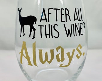 May include: A clear glass wine glass with a black silhouette of a deer and the text "After all this wine? Always." in black and gold lettering.
