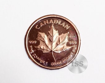 May include: A gold Canadian Maple Leaf coin with a 999 purity stamp and a 1 gram weight.