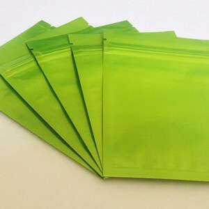 May include: Five green resealable plastic bags with a zipper closure.