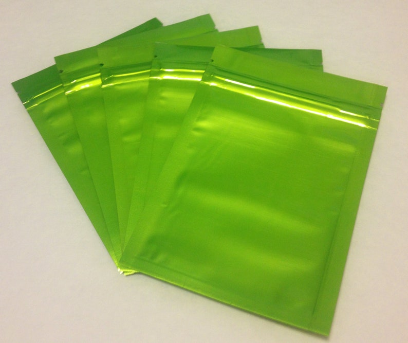 May include: A stack of five bright green resealable plastic bags with a zipper closure.