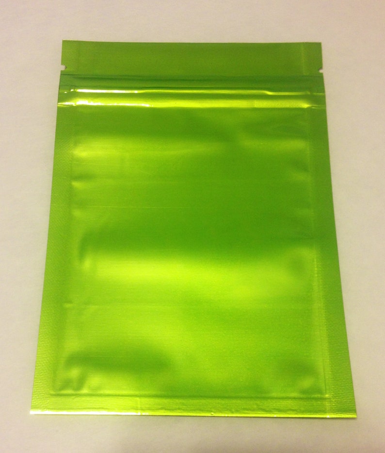 May include: A bright green resealable plastic bag with a zipper closure. The bag is made of a shiny, metallic material.