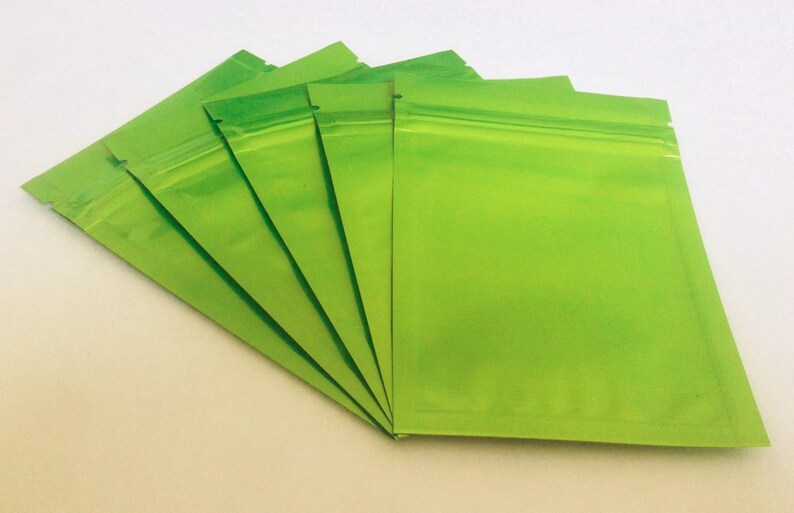May include: Five green resealable plastic bags with a zipper closure.