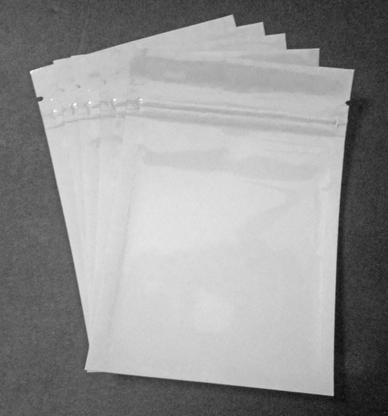 May include: A stack of five clear plastic resealable bags with a zipper closure.