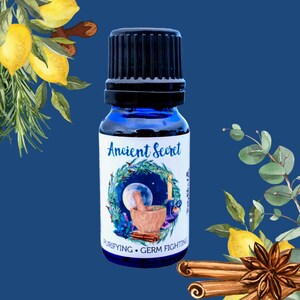 May include: A blue glass bottle with a black cap and a white label that says "Ancient Secret" with a moon and stars design. The label also says "Purifying - Germ Fighting".
