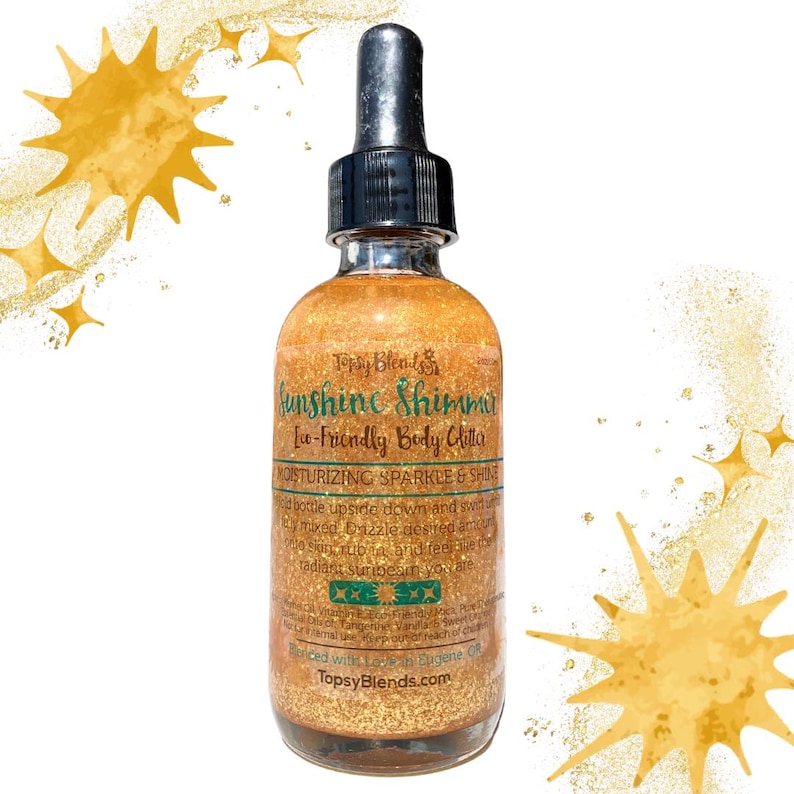 May include: A glass bottle of gold body glitter with a dropper top. The bottle label reads "Sunshine Shimmer Eco-Friendly Body Glitter" and "Moisturizing Sparkle & Shine".