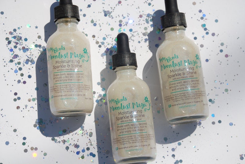 May include: Three glass bottles with a white label and a green star design. The label reads "Fairy Blends Moondust Magic Moisturizing Sparkle & Shine with eco-friendly glitter". The bottles are filled with a clear liquid with glitter.