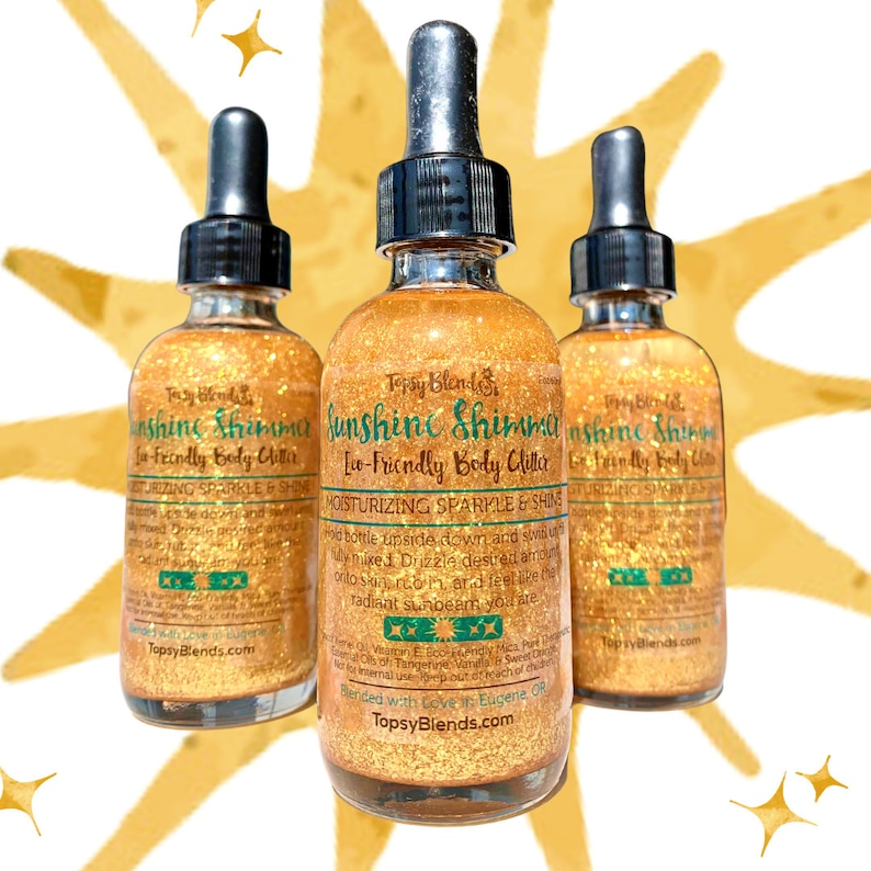 May include: Three glass bottles of gold glitter body shimmer with a green and white label that reads "Sunshine Shimmer Eco-Friendly Body Glitter Moisturizing Sparkle & Shine" and "Blended with Love in Eugene, OR TopsyBlends.com".
