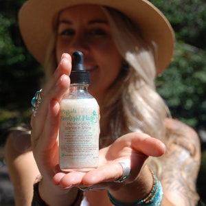 May include: A clear glass bottle with a dropper top, containing a white liquid. The bottle label reads "My Oils Moonlight Magic Moisturizing Sparkle & Shine".