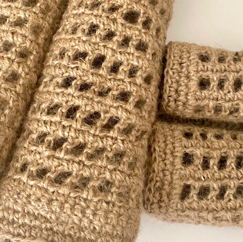May include: Close-up of a brown, crocheted, woven, jute rope with a square pattern. The rope is made of natural fibres and has a rustic look.