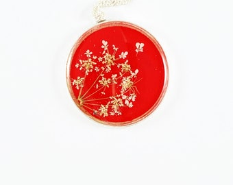 Queen Anne's lace on red resin in large circle necklace