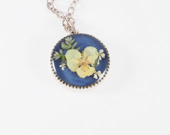 yellow viola Queen Anne's lace spike moss on blue resin in deep silver bezel