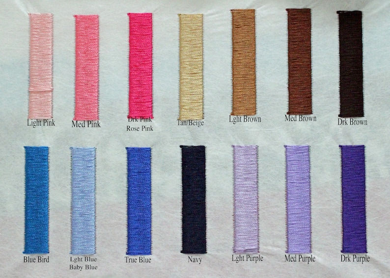 May include: A color chart featuring embroidered fabric swatches in various shades. Colors include light pink, medium pink, dark pink, tan, light brown, medium brown, dark brown, blue, purple, and navy. Each swatch has a color name label.