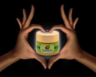 May include: A gold jar with a green leaf logo and the text "Scents 4 My Soul" and the website "www.scents4mysoul.com". The jar is surrounded by two hands forming a heart shape.