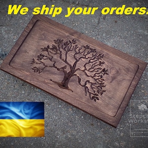 May include: A wooden serving tray with a carved tree design. The tray is dark brown and has a raised edge. The text "Stepchuk Workshop" is visible in the lower right corner.